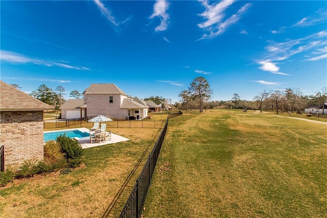 view of yard with a fenced in pool, a patio, and a fenced backyard