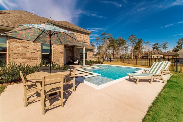 view of pool with outdoor dining space, a patio, a fenced backyard, and a fenced in pool