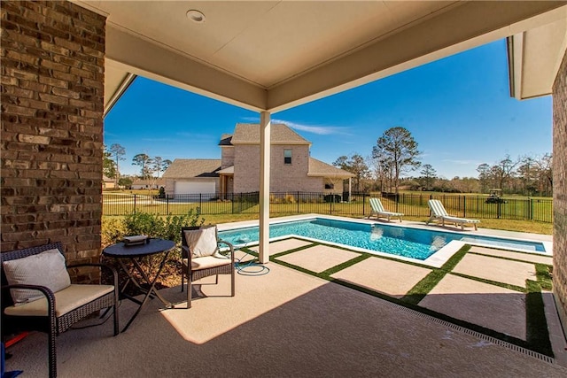 view of swimming pool with a fenced in pool, a fenced backyard, and a patio area