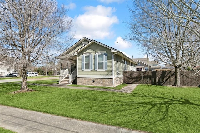 view of property exterior with a yard and fence