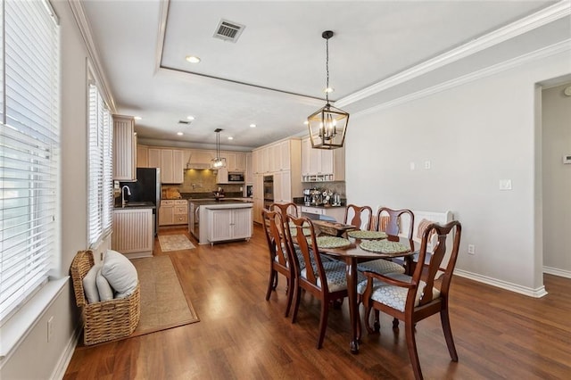 dining area with a wealth of natural light, visible vents, baseboards, and dark wood-type flooring