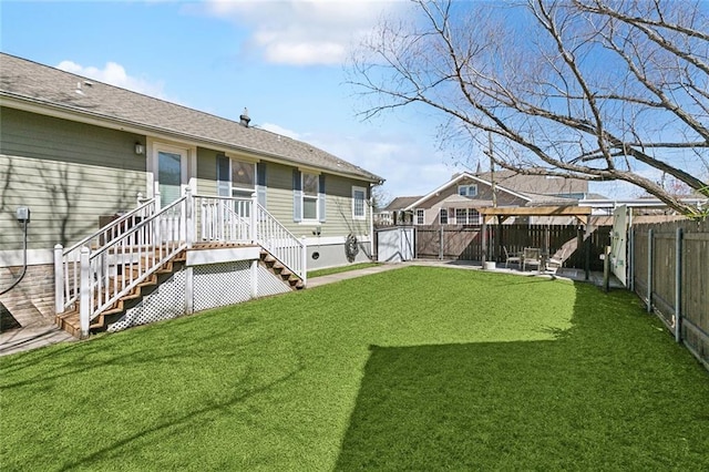 back of property with a patio, a lawn, roof with shingles, and a fenced backyard