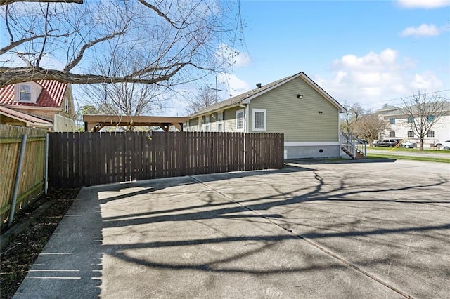 view of property exterior featuring fence