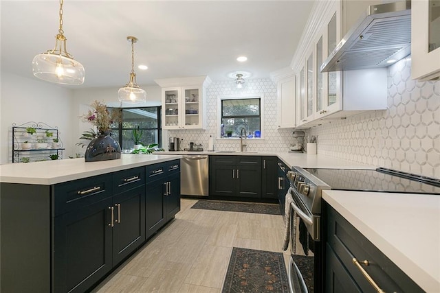 kitchen featuring under cabinet range hood, white cabinetry, stainless steel appliances, and a sink