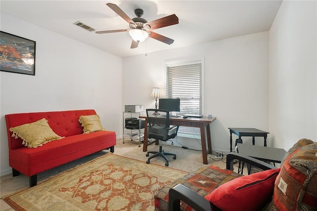 office with visible vents, carpet floors, baseboards, and a ceiling fan