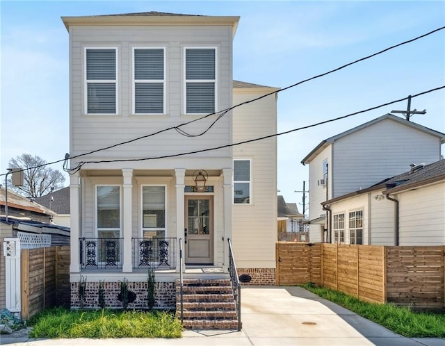 view of front of house with a porch and fence