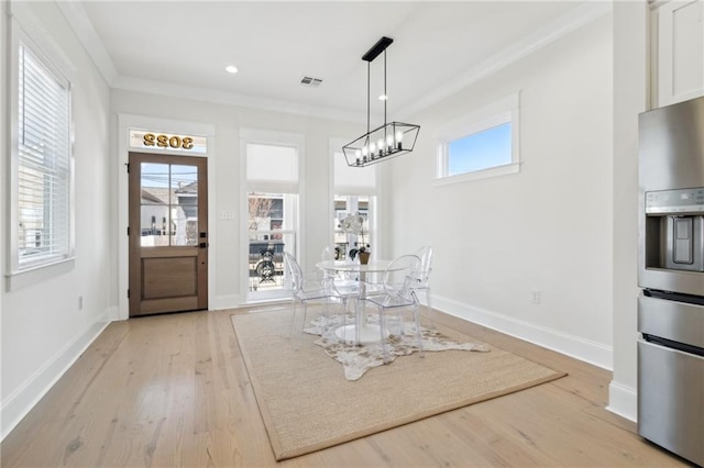 unfurnished dining area featuring light wood-type flooring, visible vents, ornamental molding, recessed lighting, and baseboards