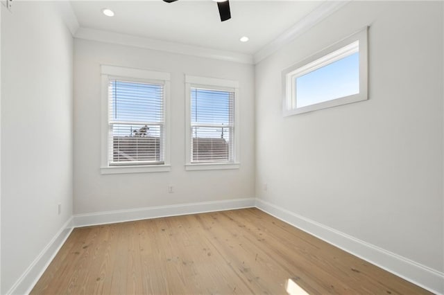 spare room featuring plenty of natural light, baseboards, and ornamental molding