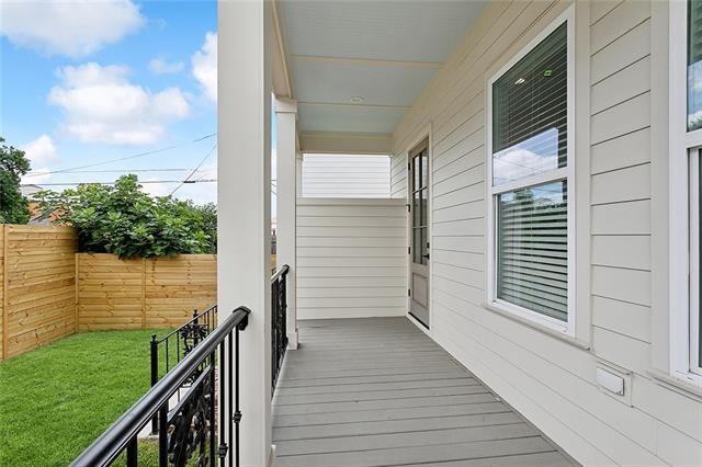 wooden terrace featuring a porch and fence