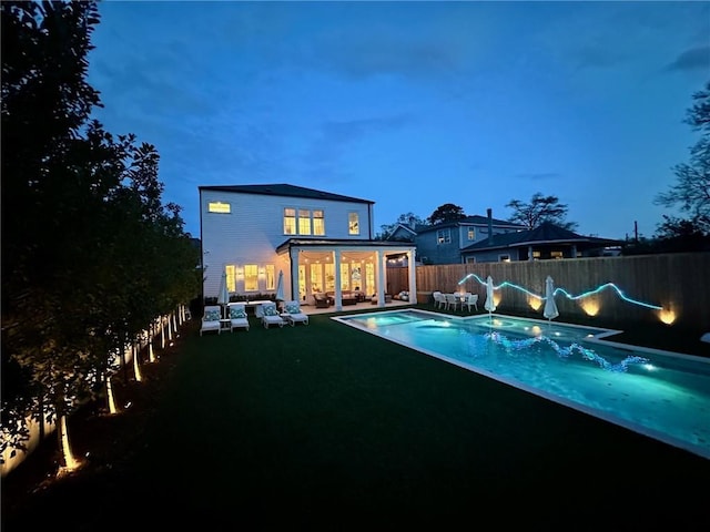 view of swimming pool featuring an outdoor living space, a fenced in pool, a patio, and a fenced backyard