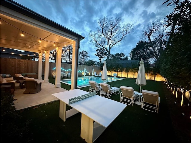 exterior space featuring an outdoor living space, a fenced in pool, and a fenced backyard