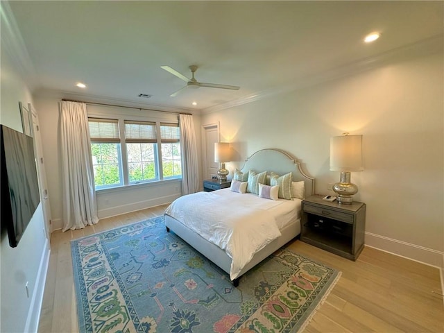 bedroom with crown molding, light wood-style flooring, recessed lighting, and baseboards