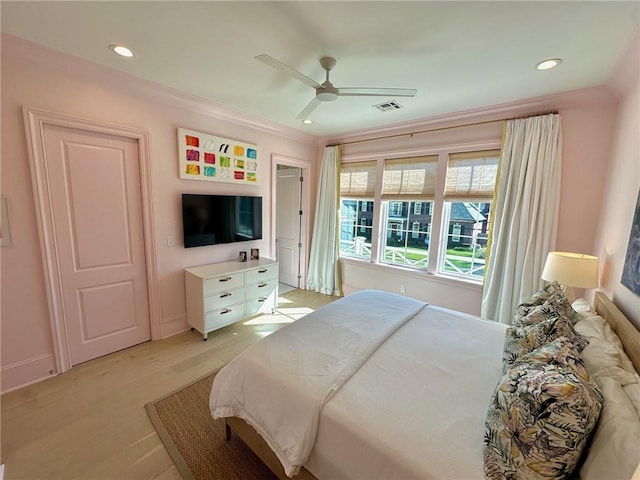 bedroom featuring visible vents, crown molding, baseboards, recessed lighting, and light wood-style floors