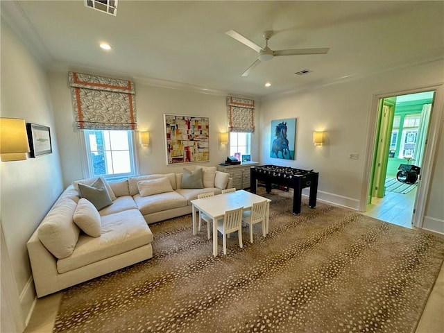 living room featuring recessed lighting, visible vents, ornamental molding, and a ceiling fan