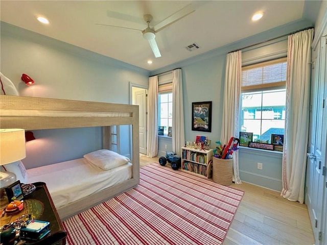 bedroom featuring light wood finished floors, visible vents, multiple windows, and recessed lighting