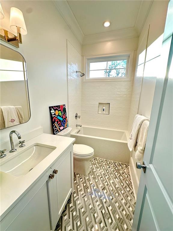 full bath with vanity, toilet, shower / washtub combination, and crown molding