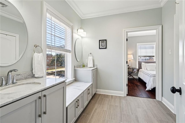 full bath with plenty of natural light, crown molding, baseboards, and wood finished floors