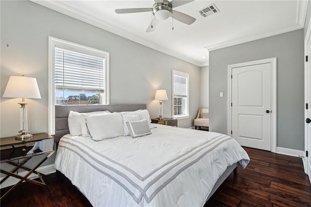 bedroom with dark wood-type flooring, crown molding, visible vents, and baseboards