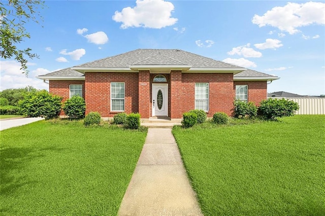 3408 Debouchel Blvd, Meraux, LA 70075 - view of front of home featuring a front yard, roof with shingles, and brick siding