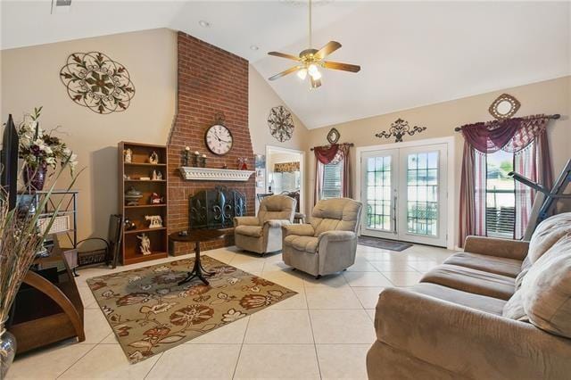 living area featuring high vaulted ceiling, a ceiling fan, french doors, a fireplace, and light tile patterned floors