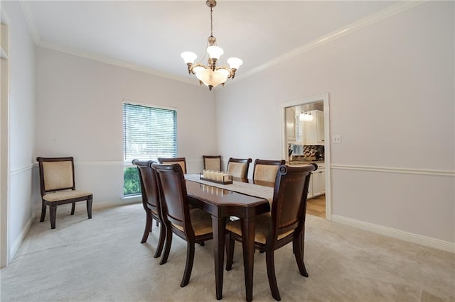 dining space with a notable chandelier, light colored carpet, crown molding, and baseboards