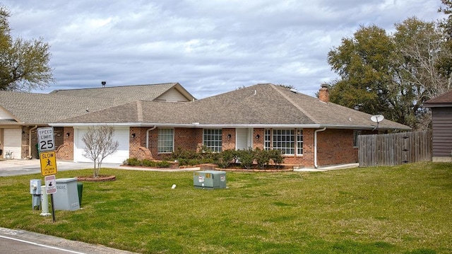 ranch-style home with brick siding, a front lawn, a garage, and roof with shingles