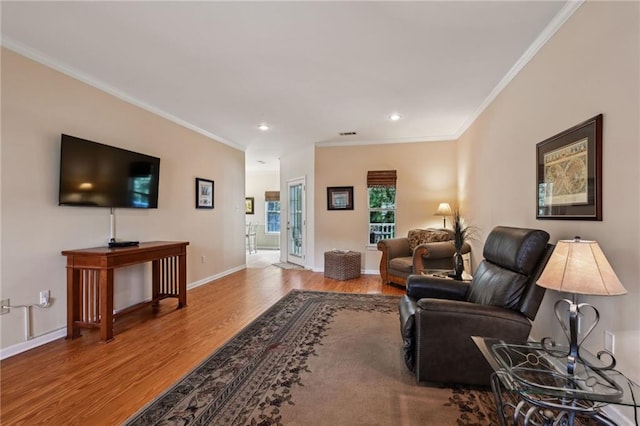 living area with recessed lighting, baseboards, wood finished floors, and crown molding