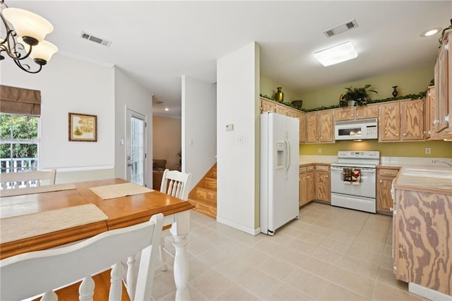 kitchen with white appliances, light countertops, visible vents, and a sink