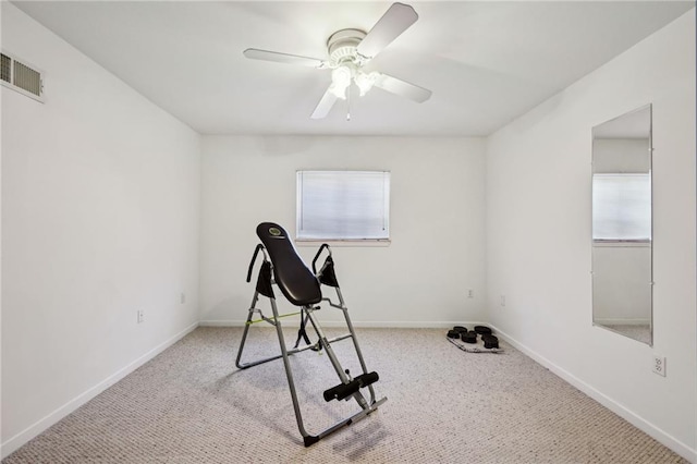 workout area with visible vents, carpet floors, baseboards, and ceiling fan