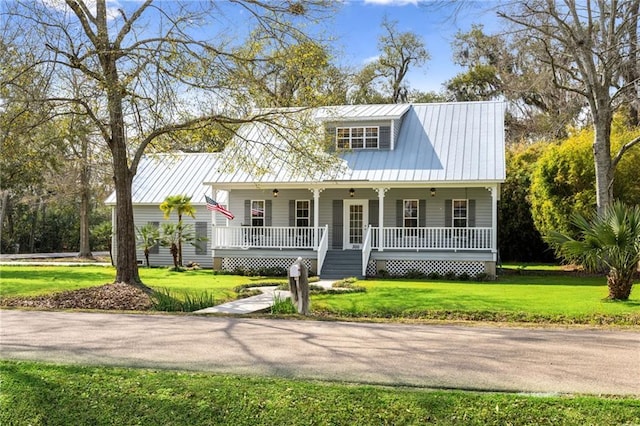 view of front of house featuring a porch, a front lawn, and metal roof