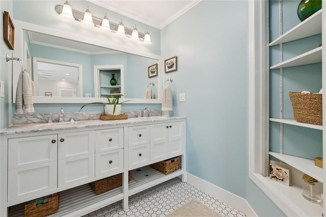 full bath with double vanity, ornamental molding, baseboards, and a sink