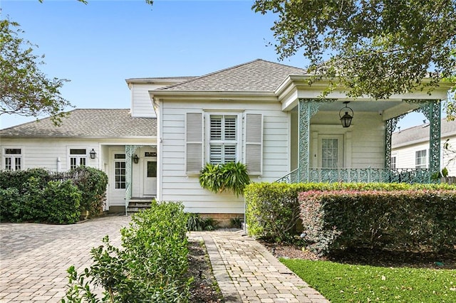 view of front of home with entry steps and roof with shingles