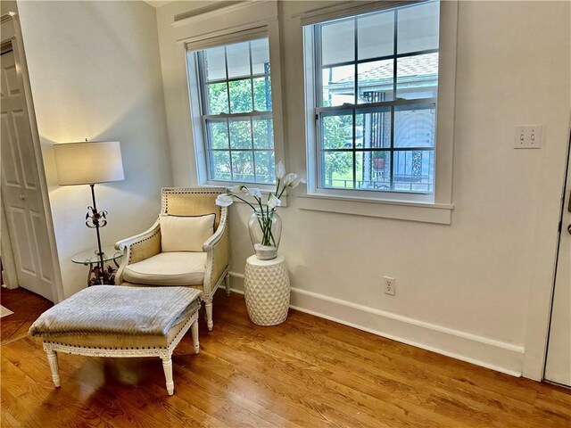 living area featuring wood finished floors and baseboards