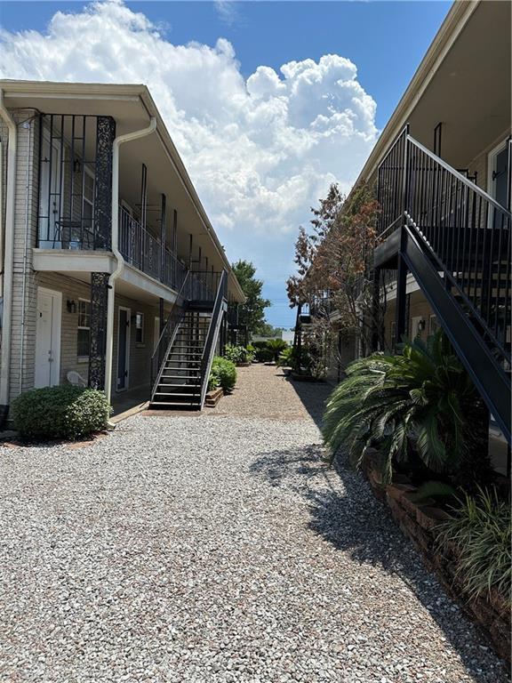 view of street featuring driveway and stairs