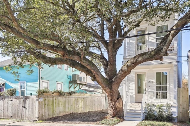 view of front of property with a fenced front yard and a balcony