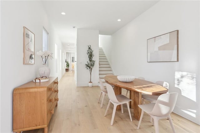 dining space featuring recessed lighting, stairs, and light wood finished floors