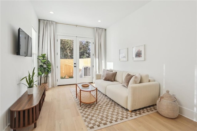 living room featuring recessed lighting, french doors, and wood finished floors