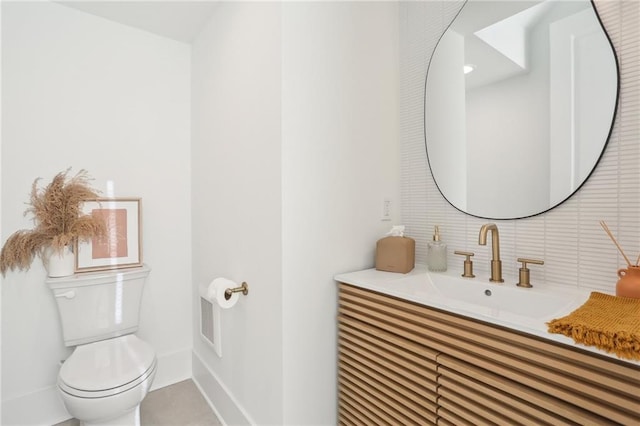 bathroom with visible vents, baseboards, toilet, and vanity