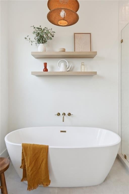 full bathroom with a soaking tub and a tile shower