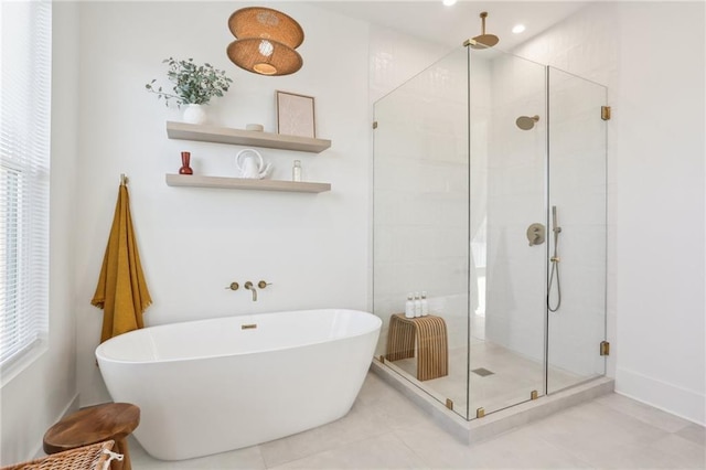 bathroom with a soaking tub and a stall shower