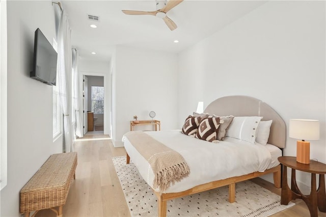 bedroom with a ceiling fan, recessed lighting, visible vents, and light wood finished floors