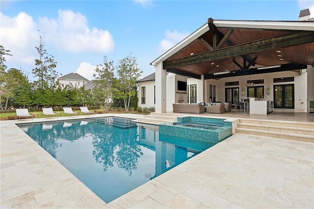 view of swimming pool featuring ceiling fan, a pool with connected hot tub, outdoor lounge area, and a patio