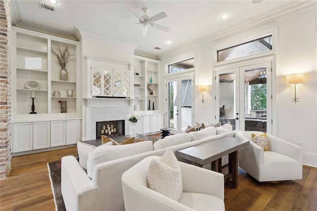 living room featuring a wealth of natural light, french doors, wood-type flooring, and visible vents