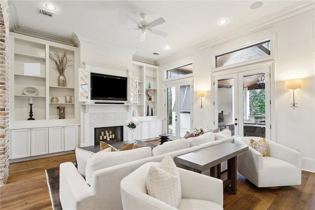 living area featuring crown molding, french doors, and visible vents