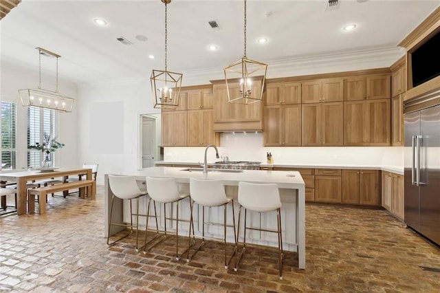 kitchen featuring visible vents, stainless steel built in refrigerator, a sink, recessed lighting, and light countertops