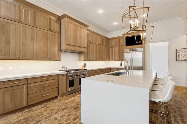 kitchen with crown molding, light countertops, brick floor, high end appliances, and a sink