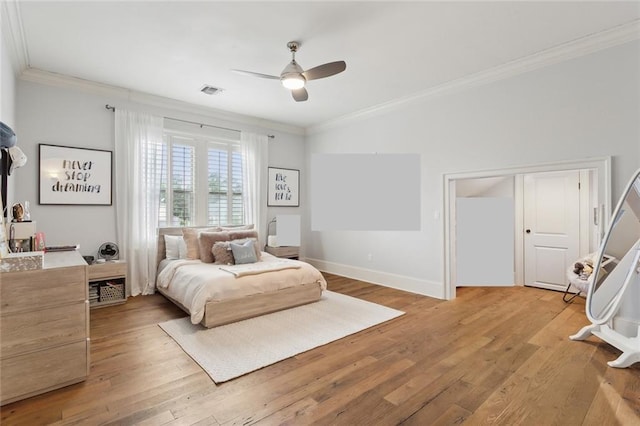 bedroom featuring ceiling fan, baseboards, light wood-style floors, and ornamental molding