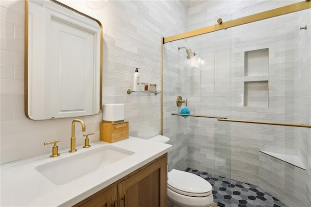 full bath with a stall shower, toilet, and vanity