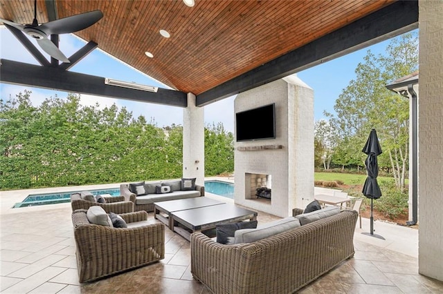 view of patio / terrace featuring an outdoor living space with a fireplace and an outdoor pool