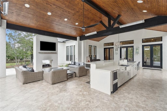 view of patio / terrace featuring a sink, french doors, outdoor wet bar, and an outdoor living space with a fireplace